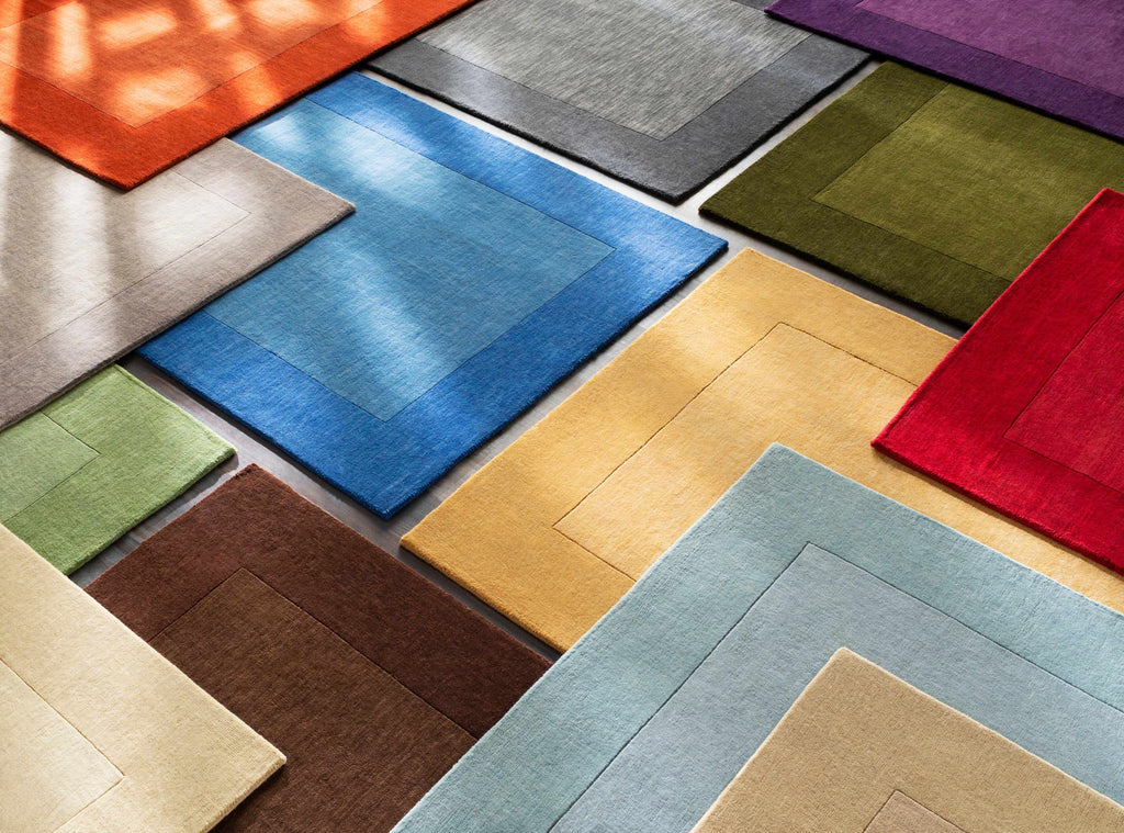 Arkabutla Solid Blue Bordered Wool Rug