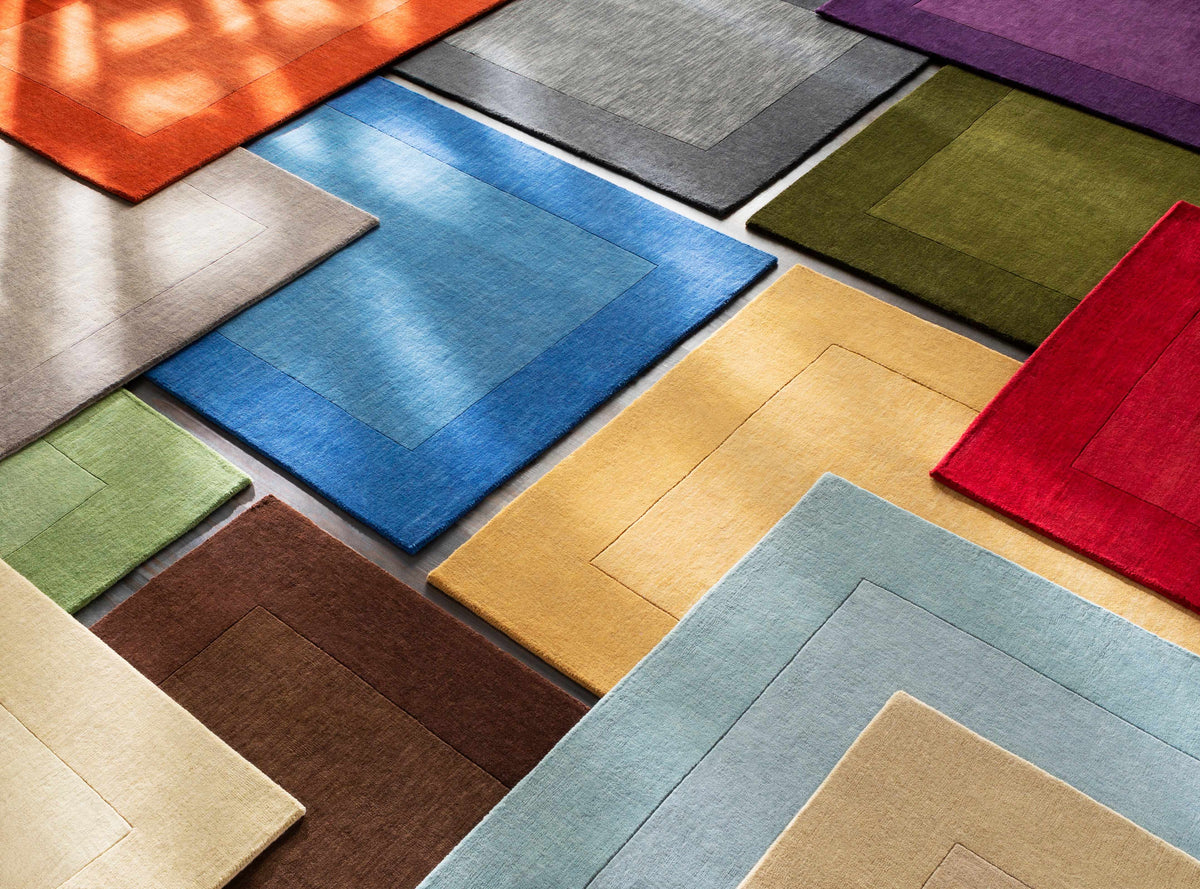 Arkabutla Solid Blue Bordered Wool Rug