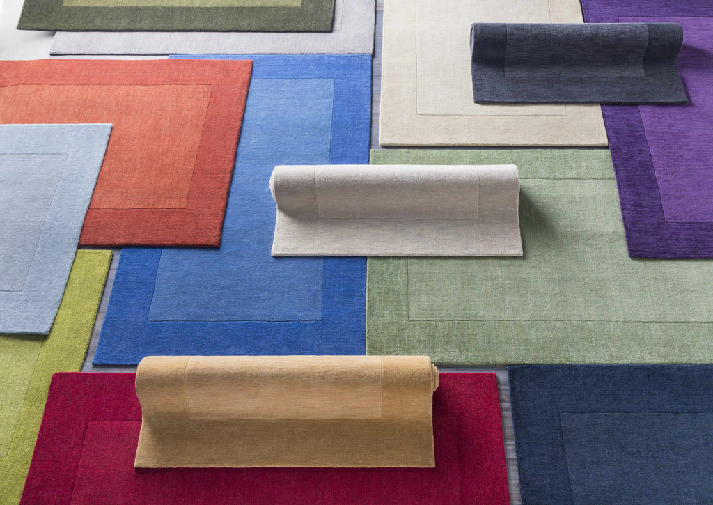 Arkabutla Solid Blue Bordered Wool Rug