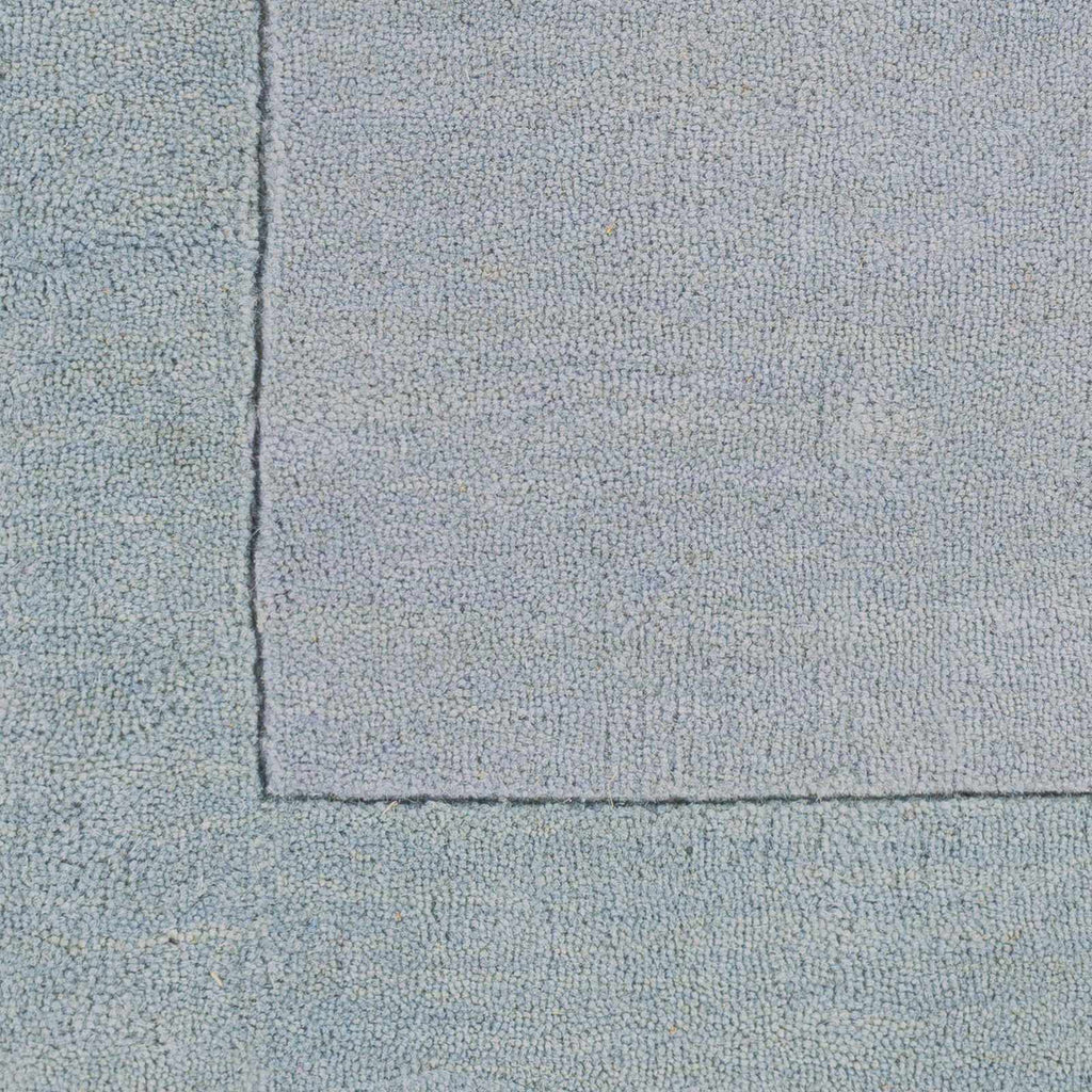 Arkabutla Solid Blue Bordered Wool Rug