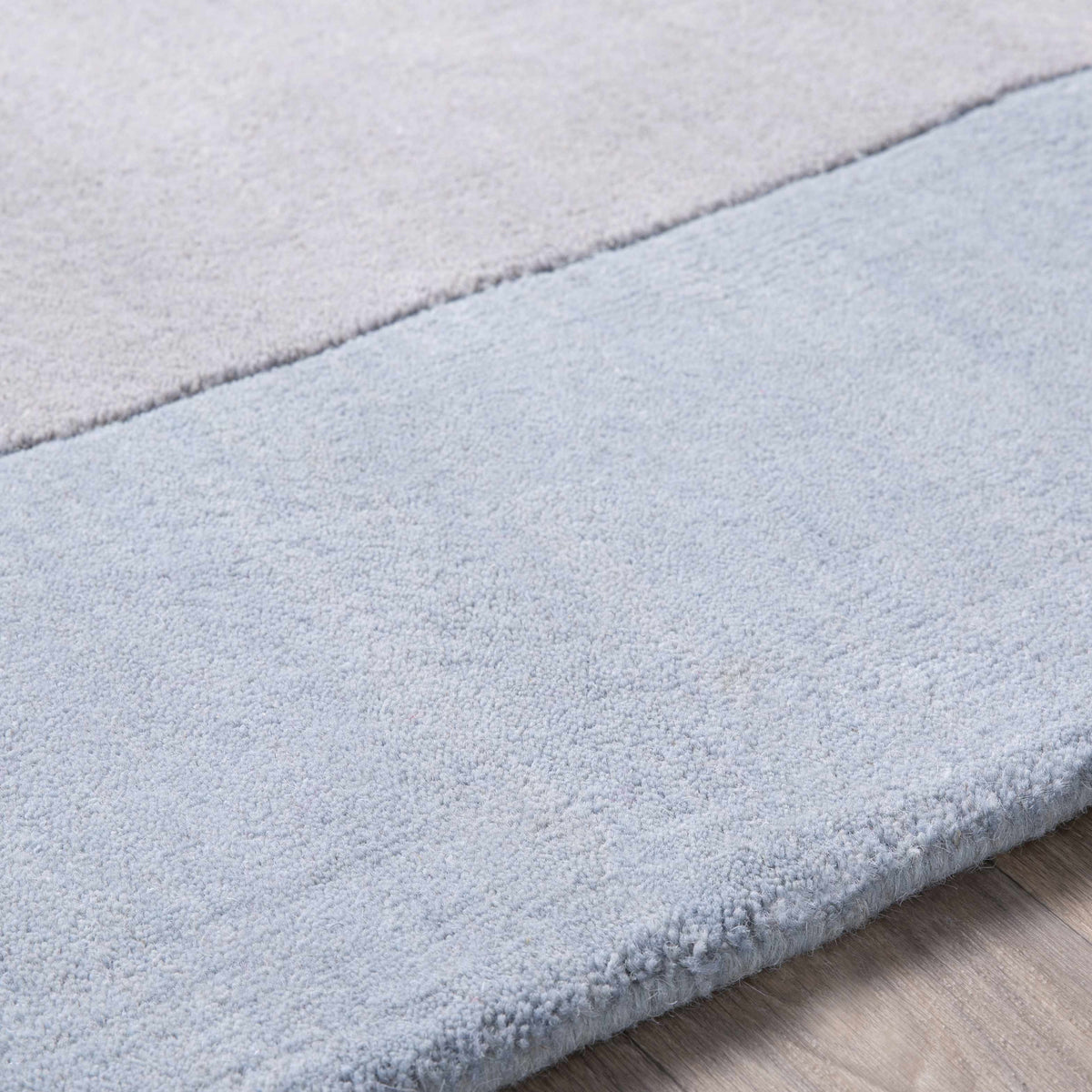 Arkabutla Solid Blue Bordered Wool Rug
